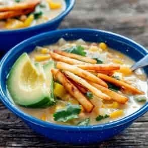 A bowl of white chili on a camp table