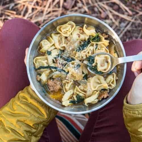 Overhead view of Megan holding a bowl of tortellini soup